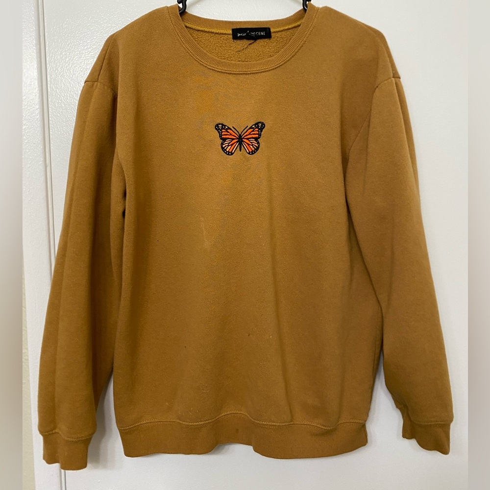Mustard Crewneck with butterfly detail in size medium.